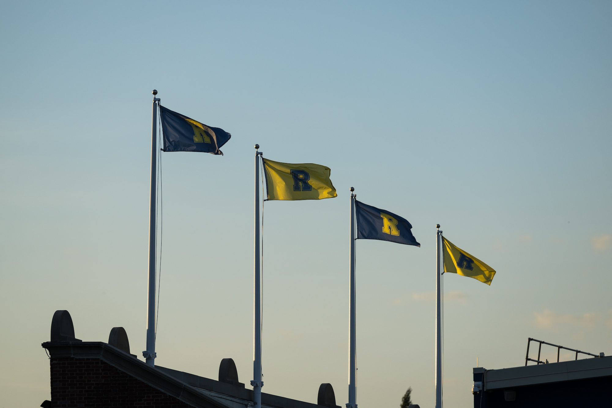 Four flags with the letter R blow in the wind