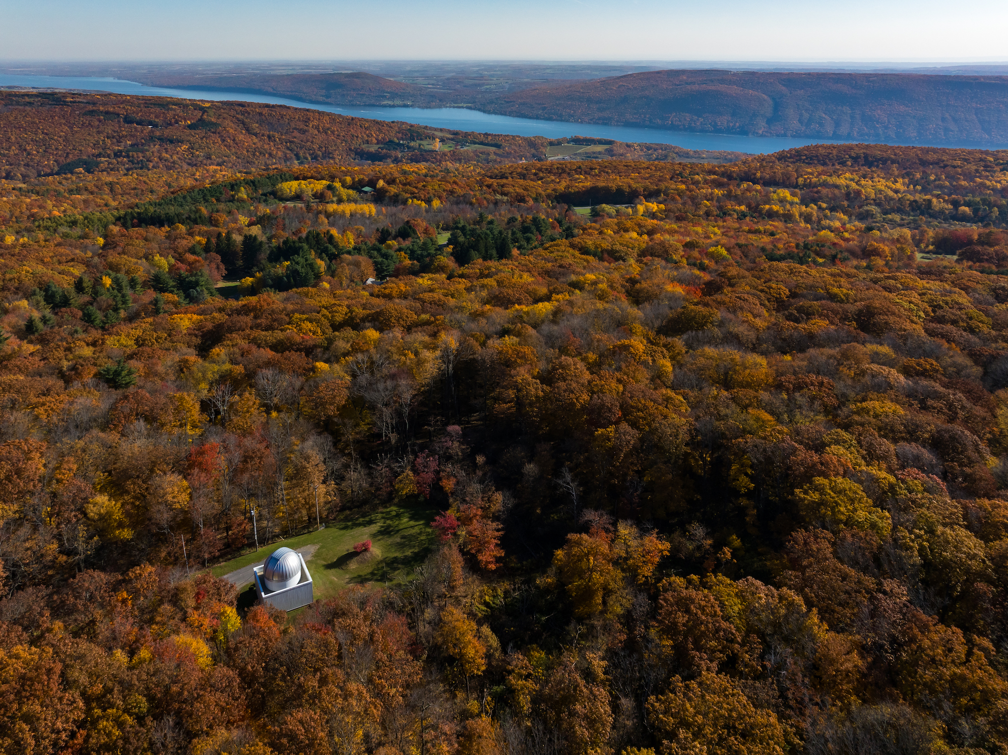 Mees Observatory surrounded by acres of fall foliage, photographed from above by drone
