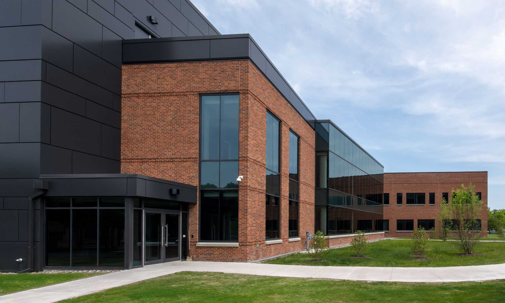 Exterior of the Laboratory for Laser Energetics building expansion against a blue sky.