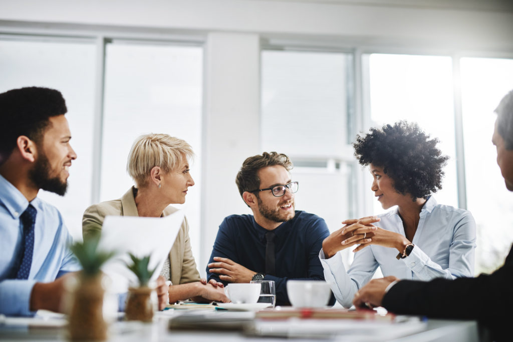 A group of employees having a conversation at a table