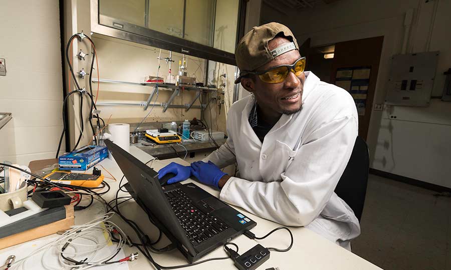 Researcher with a laptop in lab at University of Rochester